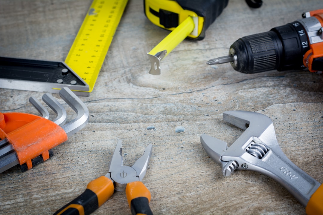 A checklist with home maintenance tasks on a clipboard, surrounded by tools like a hammer, screwdriver, and measuring tape.